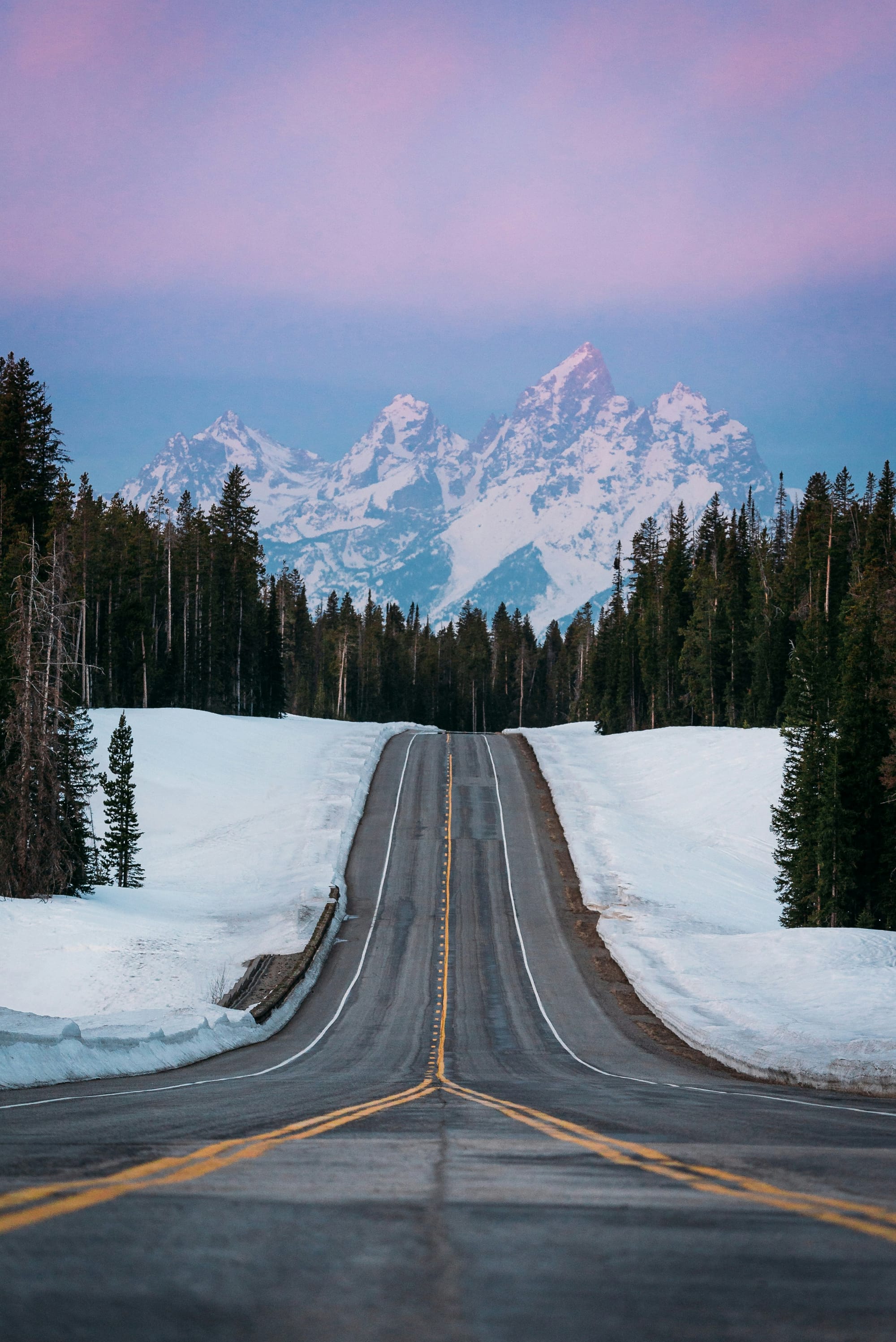 Snowy road in Grand Teton National Park in Winter, with snow.